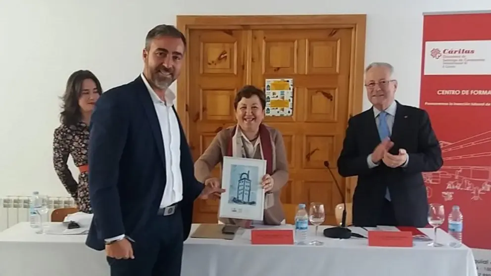 La directora de C&aacute;ritas Interparroquial de A Coru&ntilde;a, Pilar Farjas, entrega un diploma de reconocimiento al presidente de la patronal constructora, Diego V&aacute;zquez Reino.